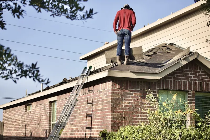 Professional roofer working on a residential roof in Northeast Warren
